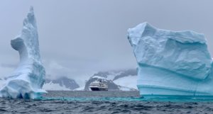 Hurtigruten ship between icebergs in Antarctica